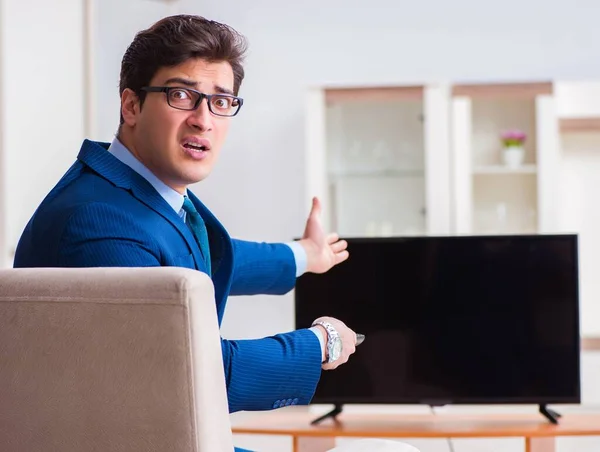 Businesman watching tv in office