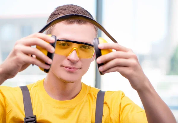 Young construction worker in yellow coveralls — Stock Photo, Image