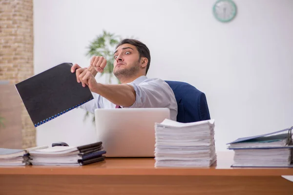 Ung affärsman och för mycket arbete på kontoret — Stockfoto