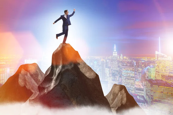 Businessman at the top of mountain in career concept — Stock Photo, Image