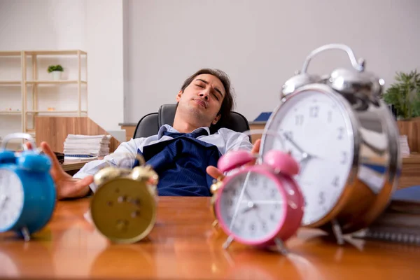 Jovem funcionário do sexo masculino dormindo no escritório em gestão de tempo co — Fotografia de Stock