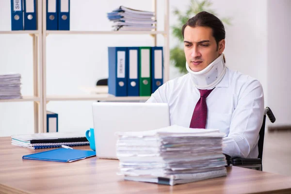 Junge männliche Angestellte im Rollstuhl am Arbeitsplatz am Hals verletzt — Stockfoto