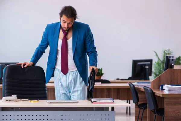 Young male employee coming to work straight from bed — Stock Photo, Image