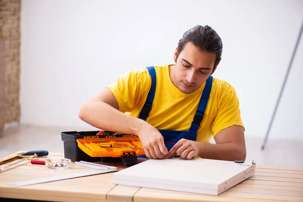 Jonge mannelijke timmerman die binnen werkt — Stockfoto