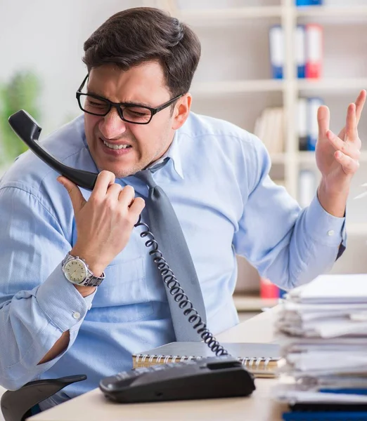 Extremely busy businessman working in office — Stock Photo, Image