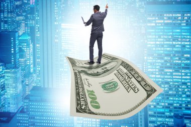 İş adamı 100 dolarlık banknotla uçuyor.