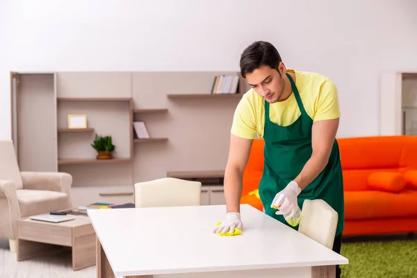 Junger männlicher Bauunternehmer putzt Haus im Haus — Stockfoto
