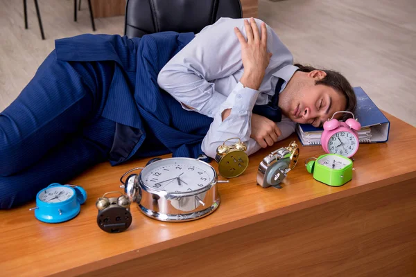 Jovem funcionário do sexo masculino dormindo no escritório em gestão de tempo co — Fotografia de Stock