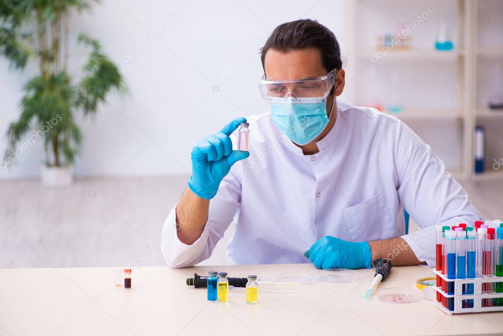 Young male chemist working in the lab