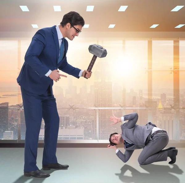 Bad angry boss threatening employee with hammer — Stock Photo, Image