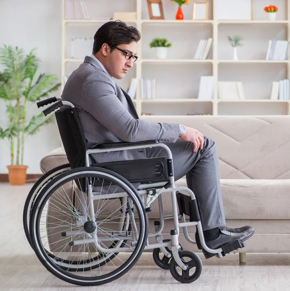 Dsabled businessman on wheelchair working home — Stock Photo, Image