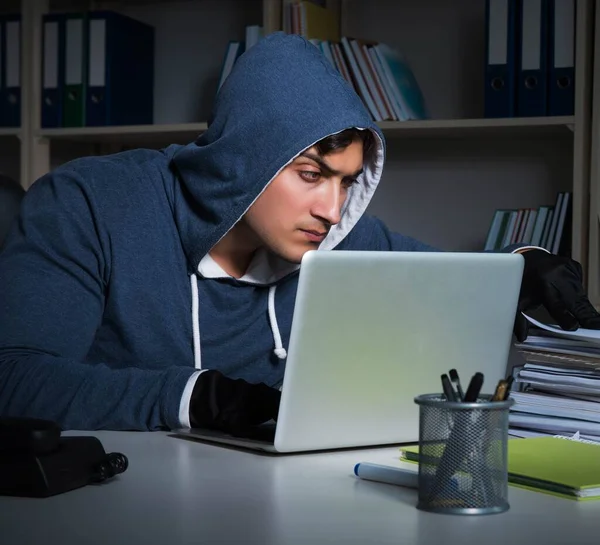 Young hacker hacking into computer at night — Stock Photo, Image