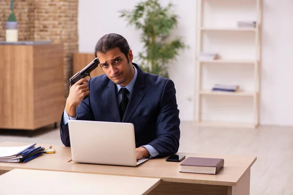 Young male employer holding gun in bankruptcy concept — Stock Photo, Image