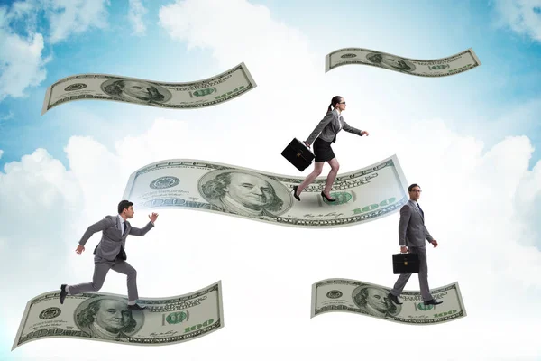 Business people flying on hundred dollar banknote — Stock Photo, Image