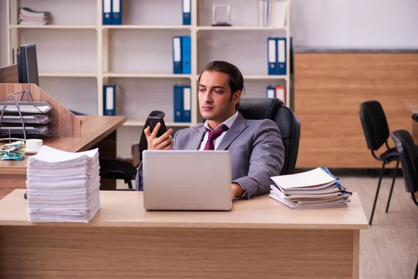 Young male employee extremely tired with excessive work — Stock Photo, Image