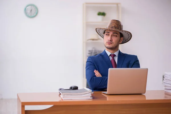 Young cowboy businessman working at workplace — Stock Photo, Image