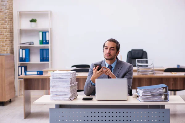 Joven empleado masculino descontento con el trabajo excesivo en la oficina — Foto de Stock