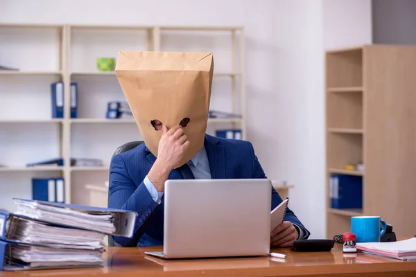 Young male employee with box instead of his head — Stock Photo, Image