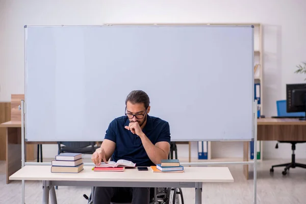 Young male handicapped student in the classroom — Stock Photo, Image