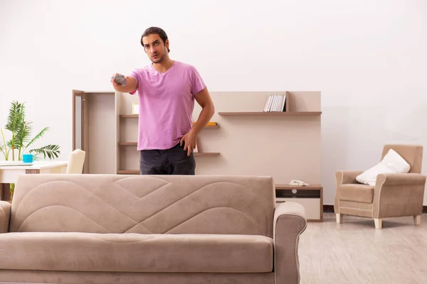 Young man watching tv at home during pandemic — Stock Photo, Image