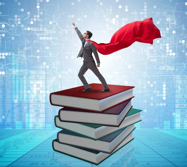 Superhero businessman in education concept with books