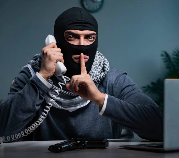 Terrorist wearing balaclava talking on phone — Stock Photo, Image