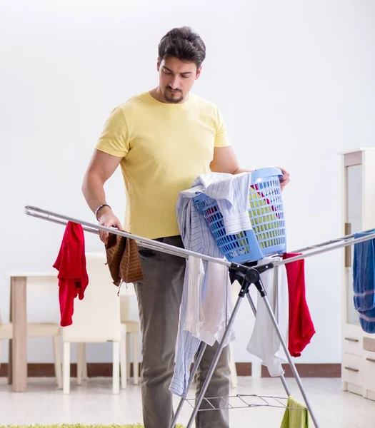 Yakışıklı koca evde çamaşır yıkıyor. — Stok fotoğraf