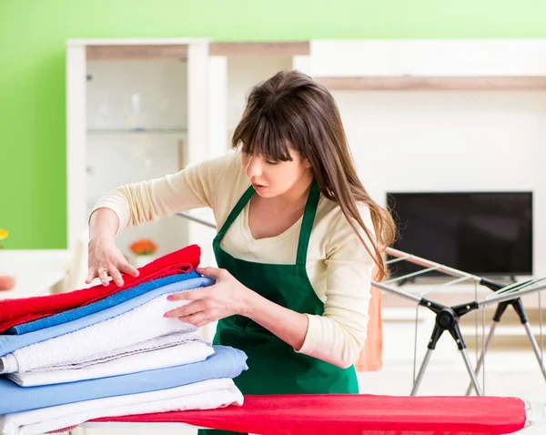 Young woman ironing clothing at home — Stock Photo, Image