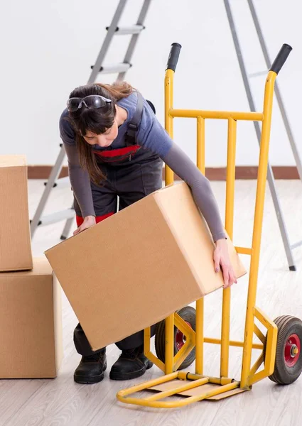 Woman contractor moving boxes in relocation concept — Stock Photo, Image