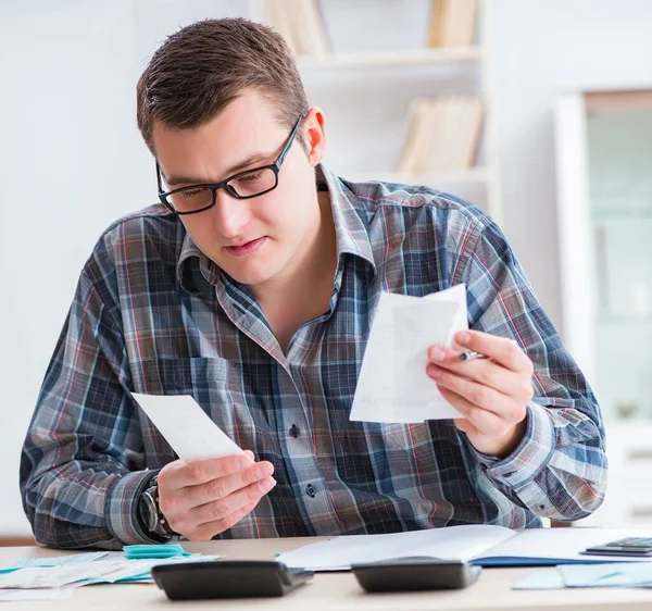 Young man frustrated at his house and tax bills — Stock Photo, Image