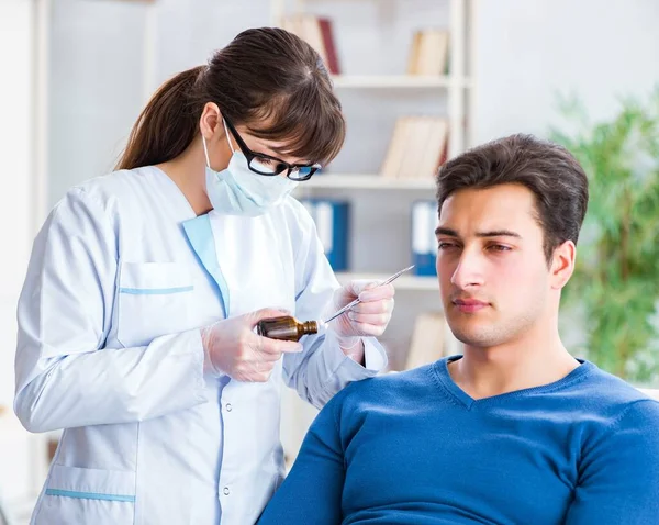 Doctor checking patients ear during medical examination