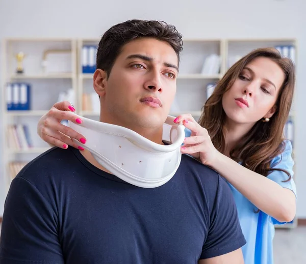 Man with neck injury visiting doctor for check-up