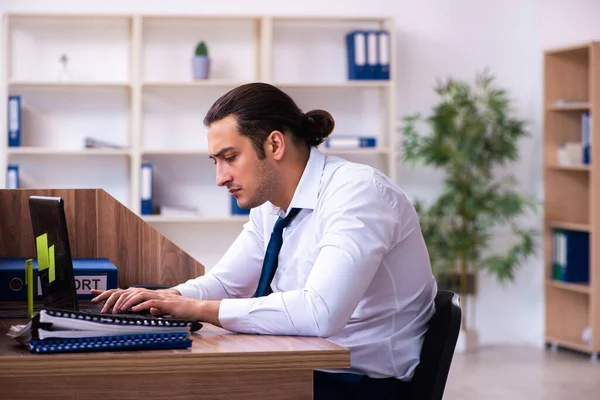 Junge männliche Angestellte unzufrieden mit exzessiver Arbeit im Büro — Stockfoto