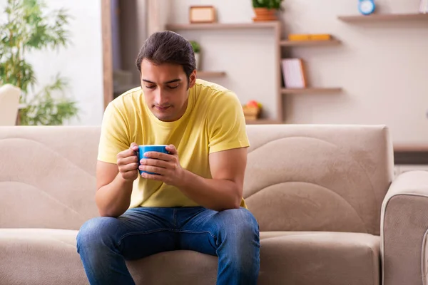 Young man student drinking coffee at home — Stock Photo, Image