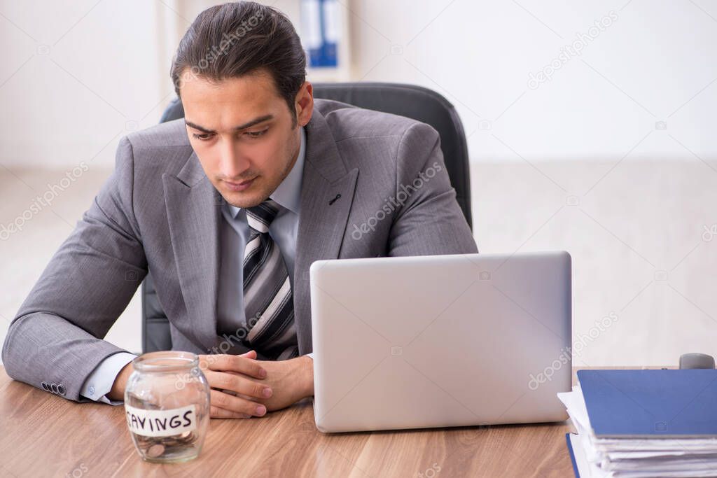 Young male employee in pension concept at workplace