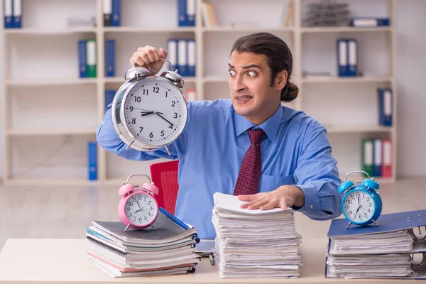 Young male employee in time management concept — Stock Photo, Image