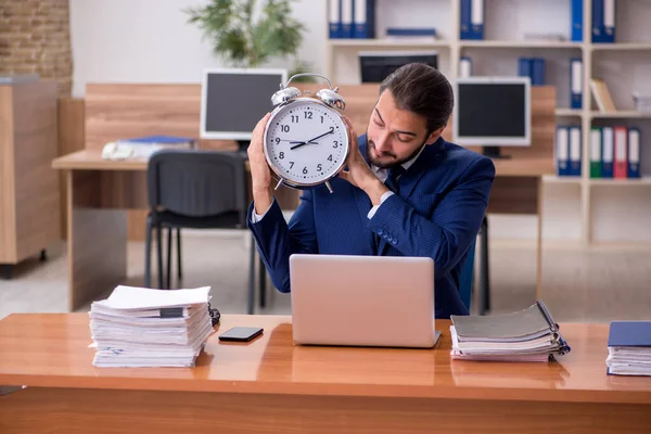 Young businessman employee in time management concept