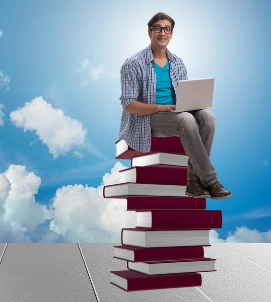 Young man in telelearning concept with laptop and books