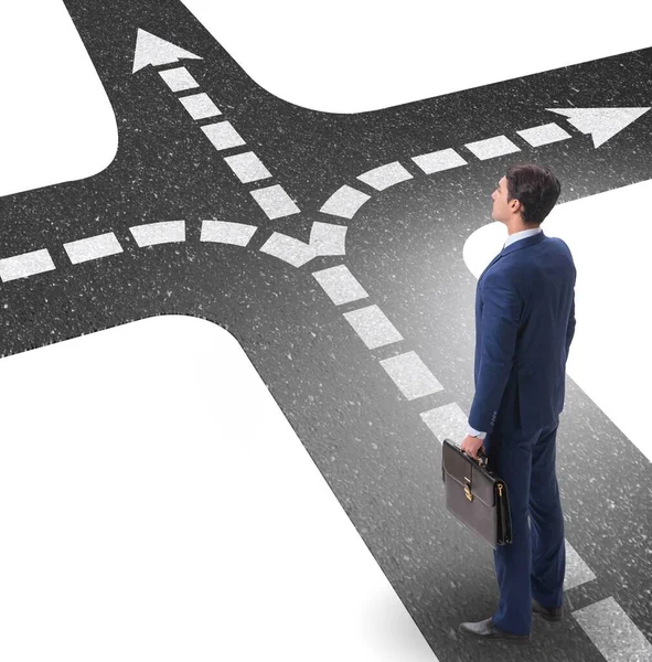 Young businessman at crossroads in uncertainty concept — Stock Photo, Image