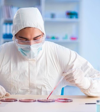 Laboratuvar asistanı hastanede kan örneklerini test ediyor.