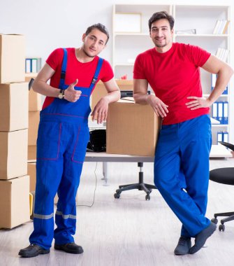 İki müteahhit personel kişisel eşyalarını taşıyor.