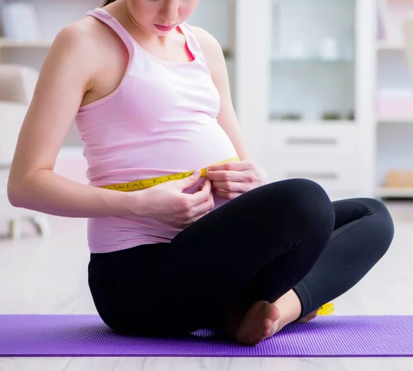 Mulher grávida se exercitando em antecipação ao parto — Fotografia de Stock