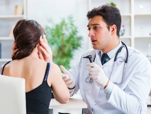 Doctor checking patients ear during medical examination