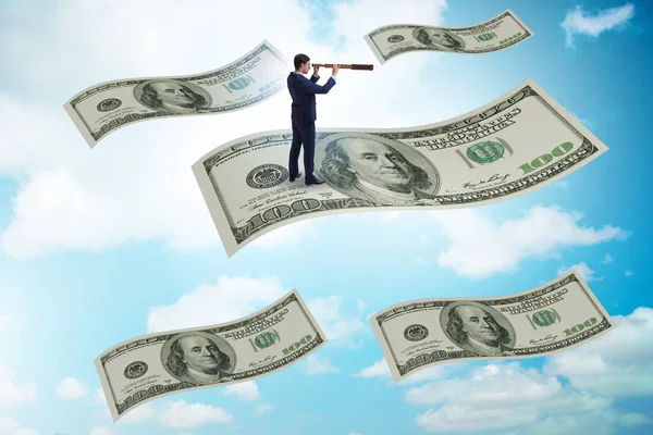 Empresario volando en billetes de cien dólares —  Fotos de Stock