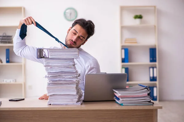 Young businessman employee unhappy with excessive work in the office — Stock Photo, Image