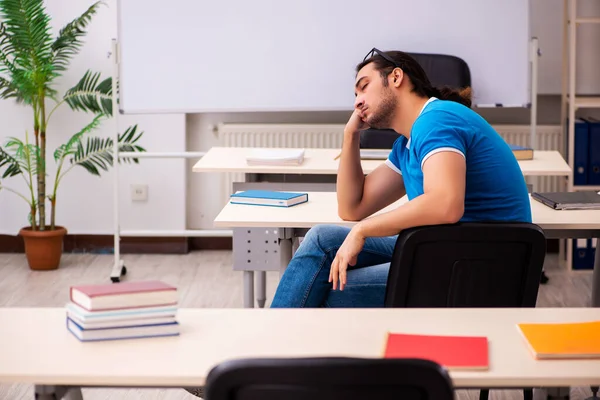 Young male student in the classroom — Stock Photo, Image