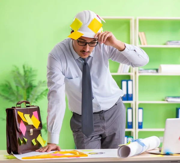 Ingeniero masculino trabajando en un nuevo proyecto con muchos conflictivos anteriores — Foto de Stock