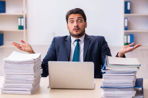 Empleado joven de negocios y demasiado trabajo en la oficina — Foto de Stock