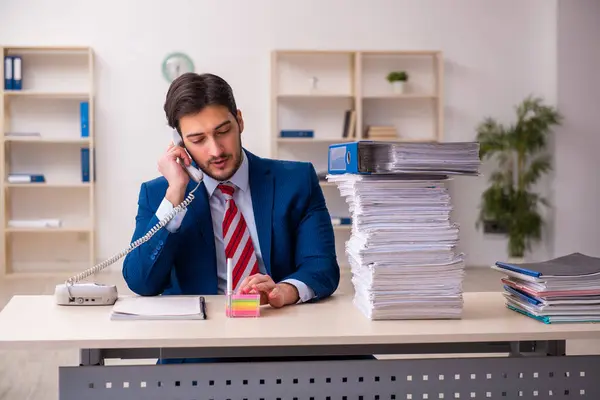 Young businessman employee unhappy with excessive work in the office — Stock Photo, Image