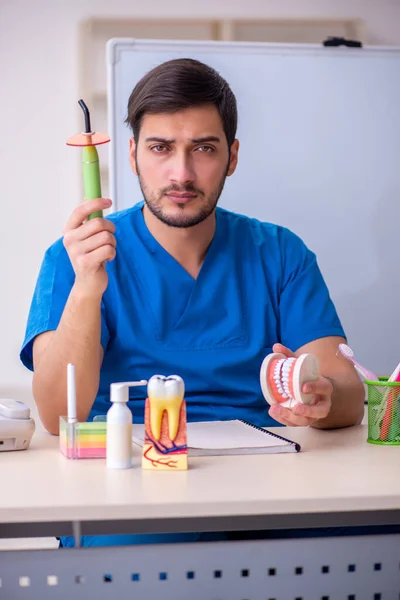 Jonge mannelijke tandarts docent voor whiteboard — Stockfoto